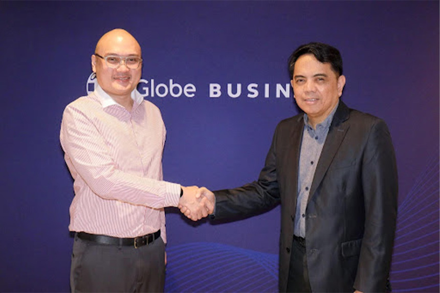 Globe Business and PhilCare representatives shook hands at the contract signing.