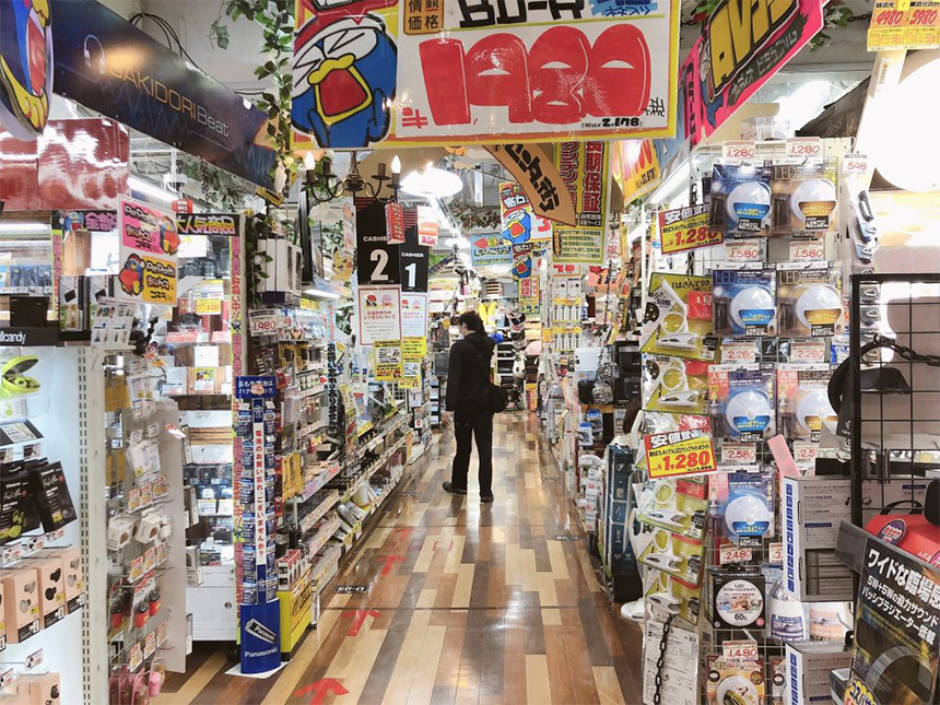 Asian man looking for electronics in Don Quijote, Tokyo