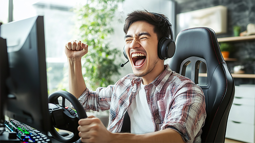 Asian man playing on his computer.