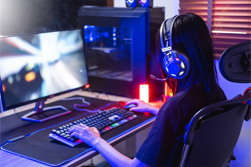 A girl playing computer games at home.