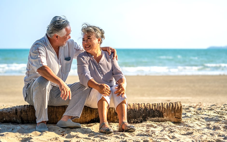 A happy senior couple enjoys a peaceful day at the beach.