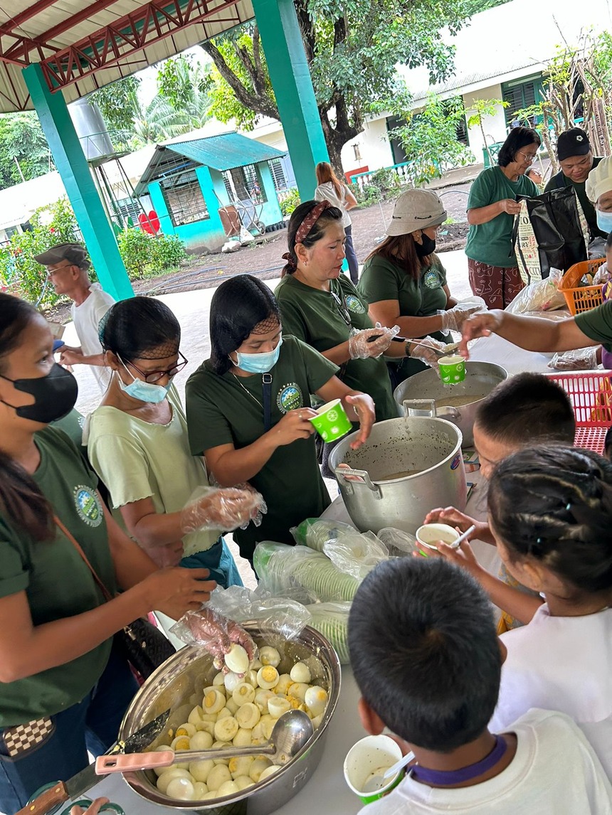 Students receiving food as part of the Hapag Movement.