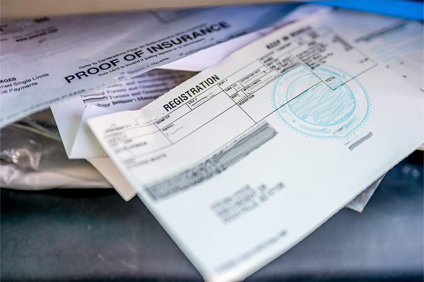 Photo of vehicle registration papers in the glove compartment.
