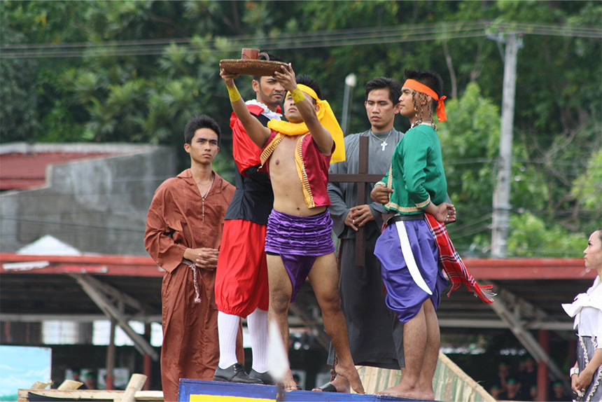 A group of five people in colorful costumes during an outdoor performance.