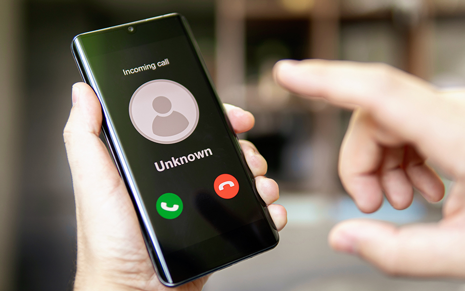 Smartphone showing an incoming call from "Unknown" with answer and decline buttons visible.