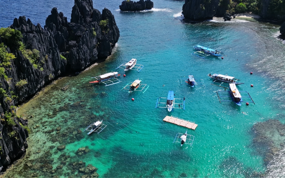 Tropical island with boats in lagoons in El Nido, Palawan.