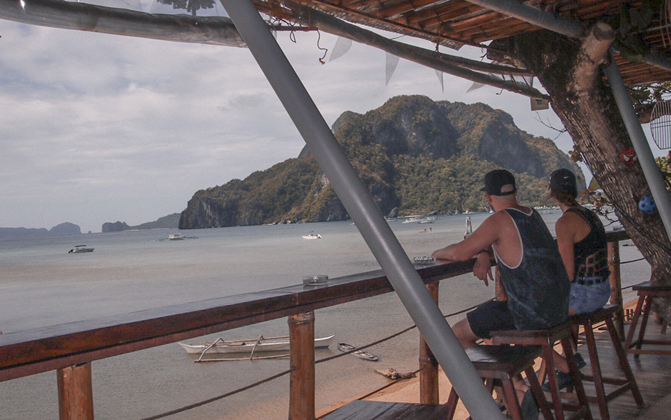 An image of an outdoor lounge with people sitting watching the view in El Nido, Palawan.